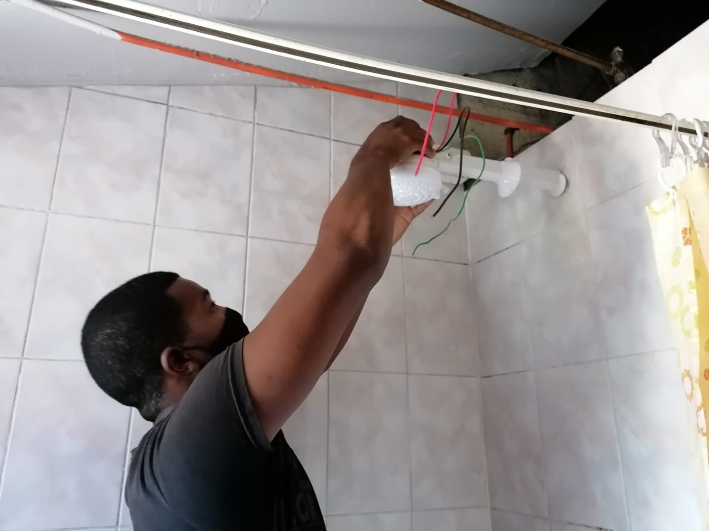 R&D technician wiring an instant electric shower
